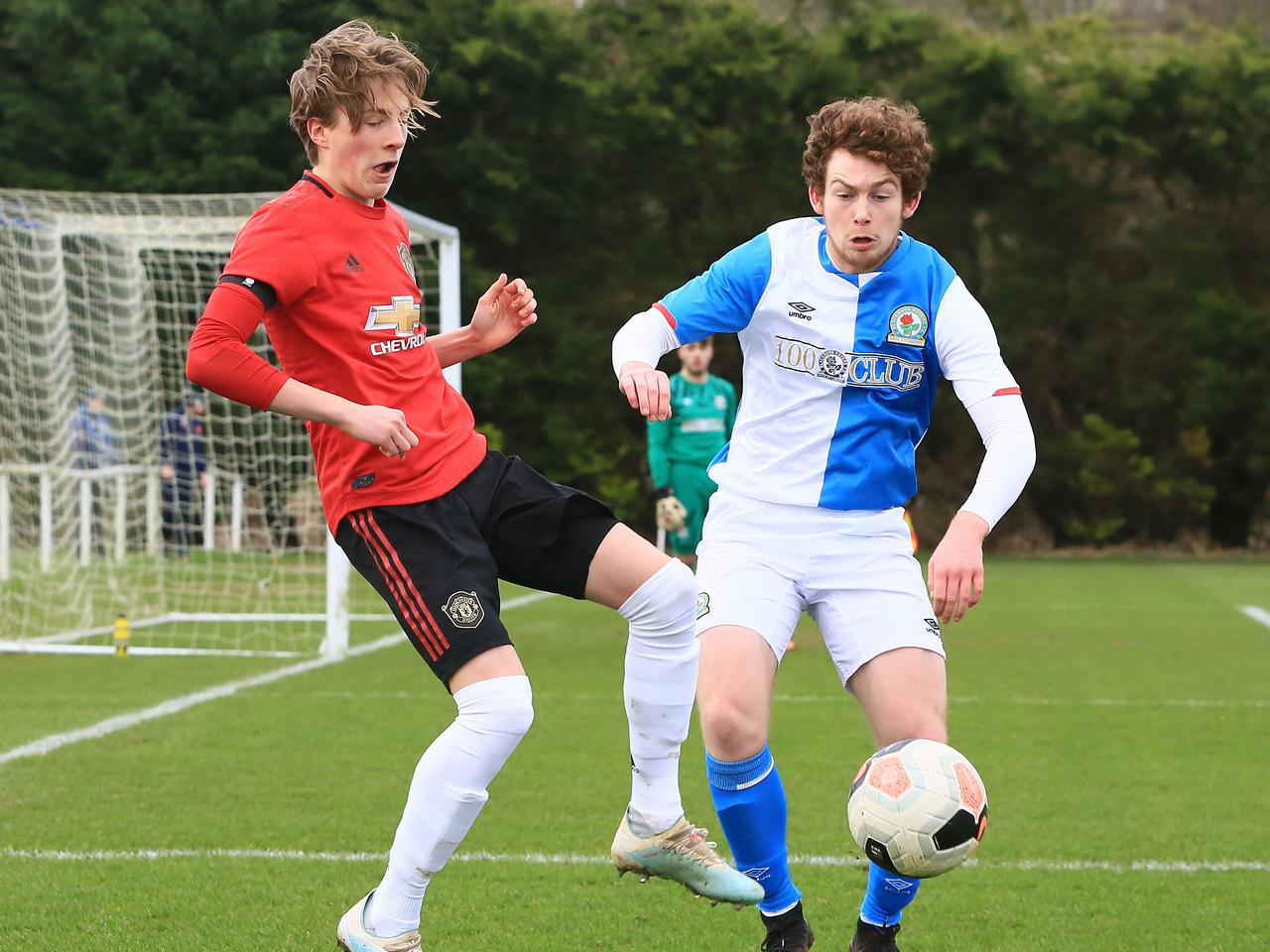 Charlie Savage competes for the ball just outside the Blackburn penalty area.
