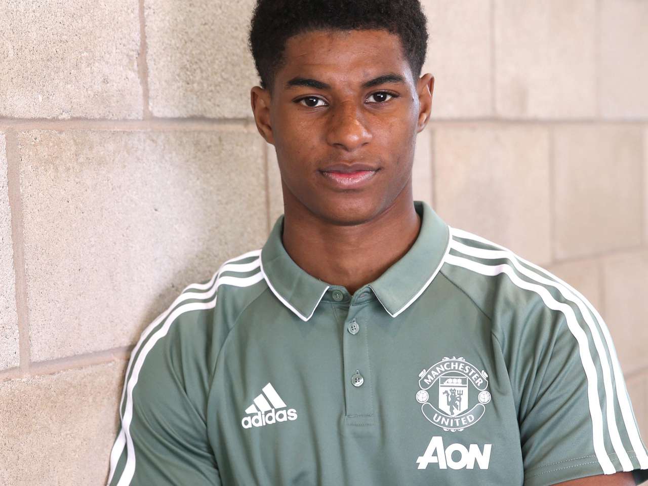 Marcus Rashford posing for a photoshoot at the Aon Training Complex.