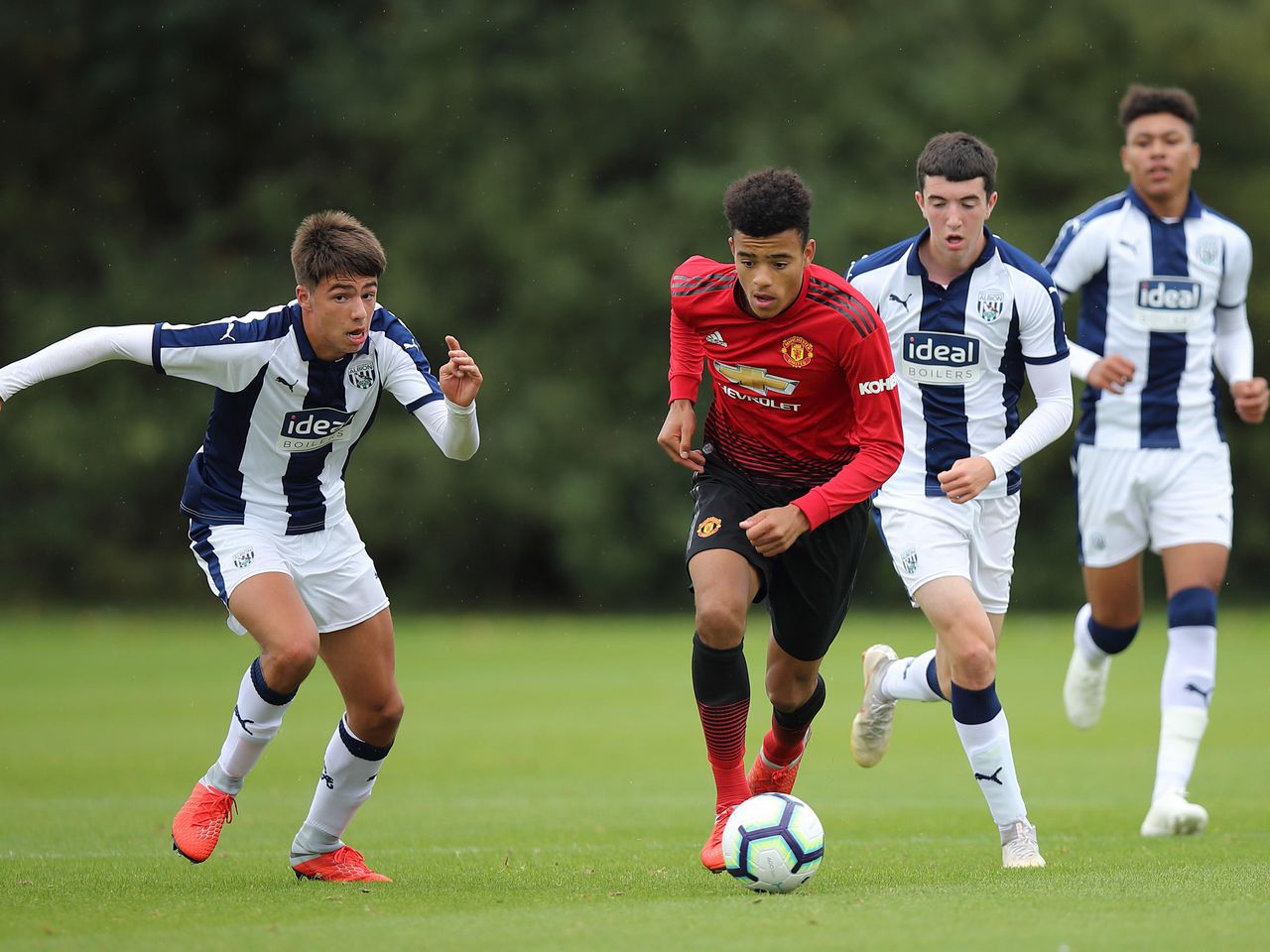 Mason Greenwood is surrounded by defenders.