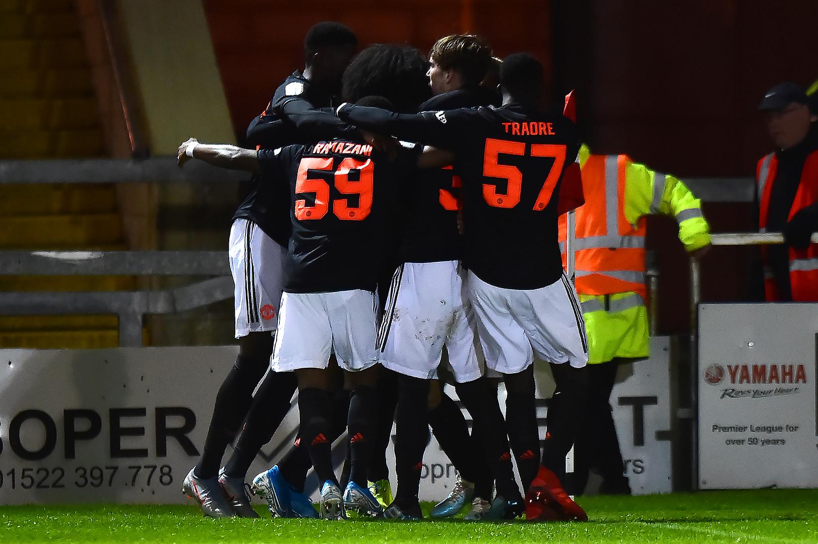 United celebrate James Garner's winner at Lincoln City.