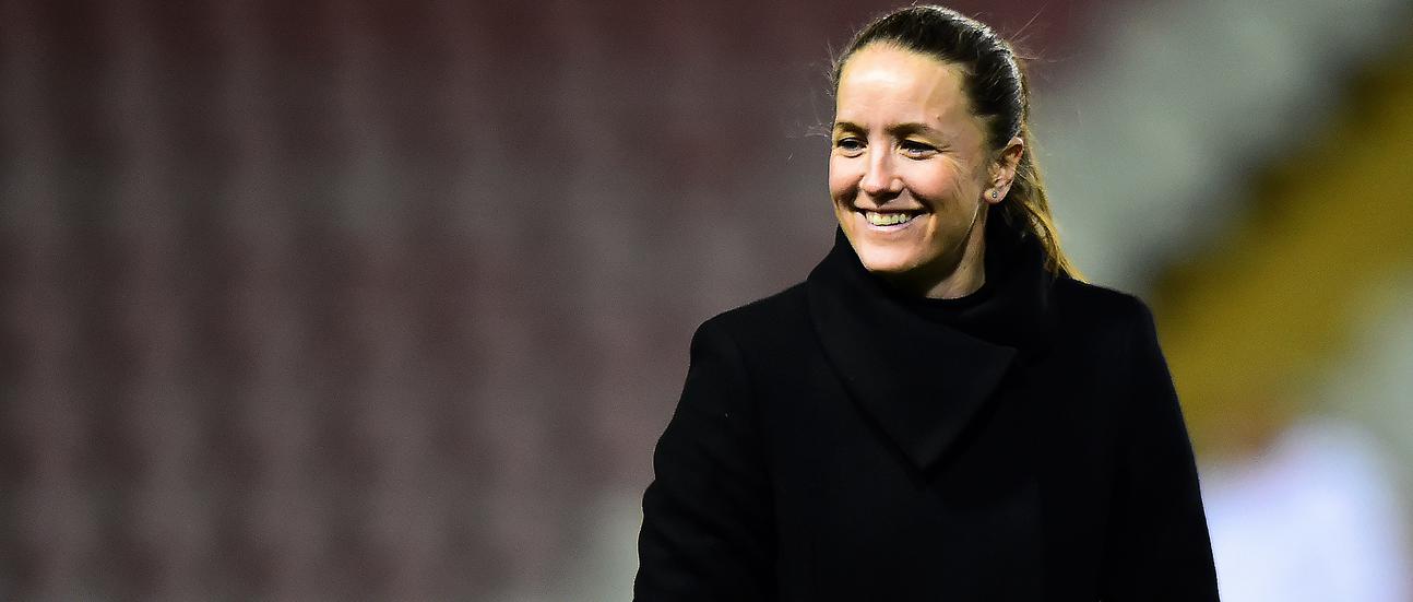 Casey Stoney watches on from the sidelines as United take on Chelsea.