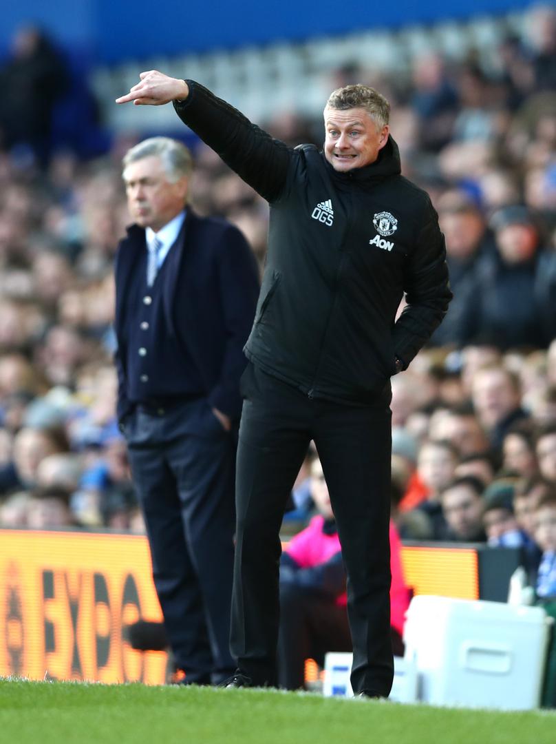 Ole Gunnar Solskjaer instructs his players as Carlo Ancelotti watches on