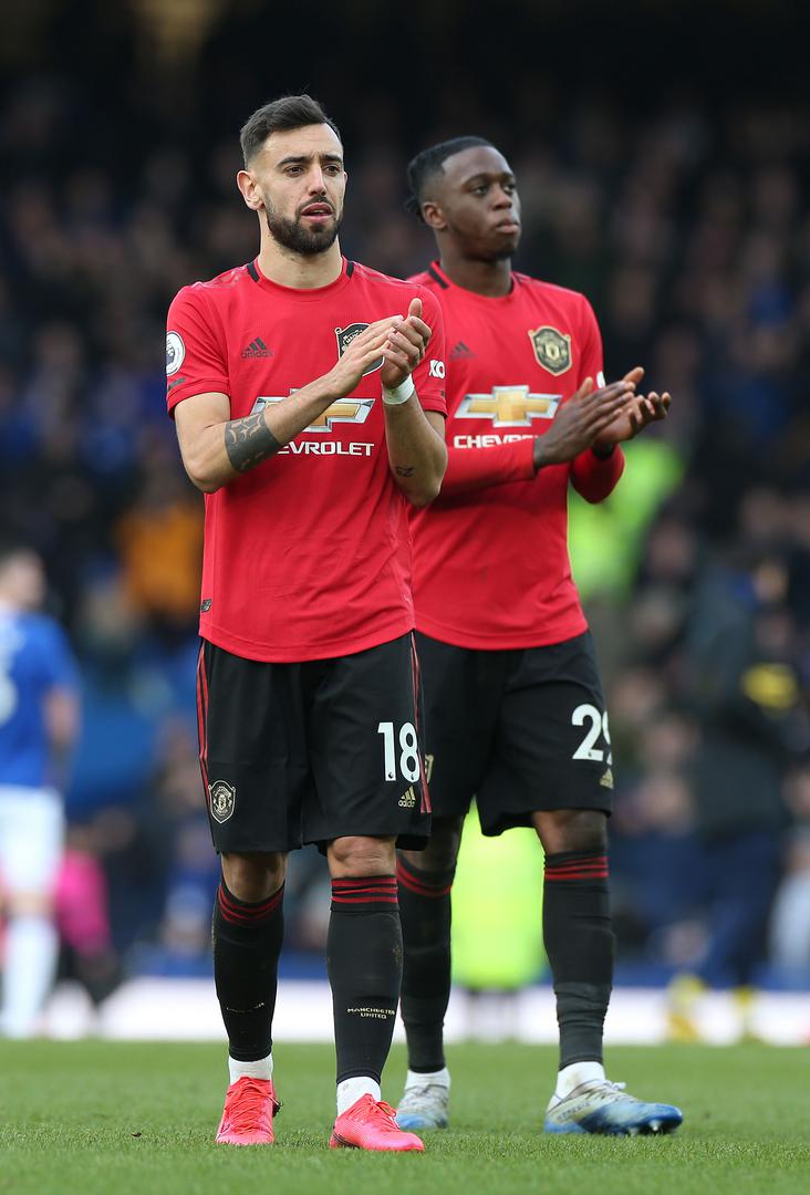 Bruno Fernandes and Aaron Wan-Bissaka applaud the visiting Man Utd supporters