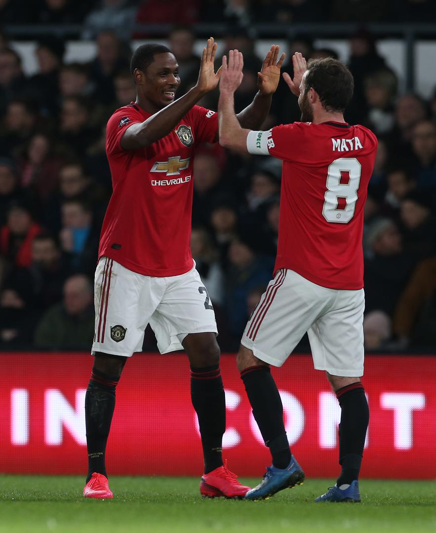 Odion Ighalo celebrates with Juan Mata