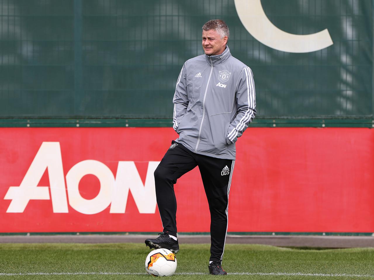 Ole Gunnar Solskjaer stands on the ball