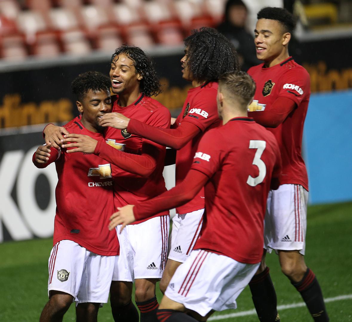 Angel Gomes is mobbed after scoring.