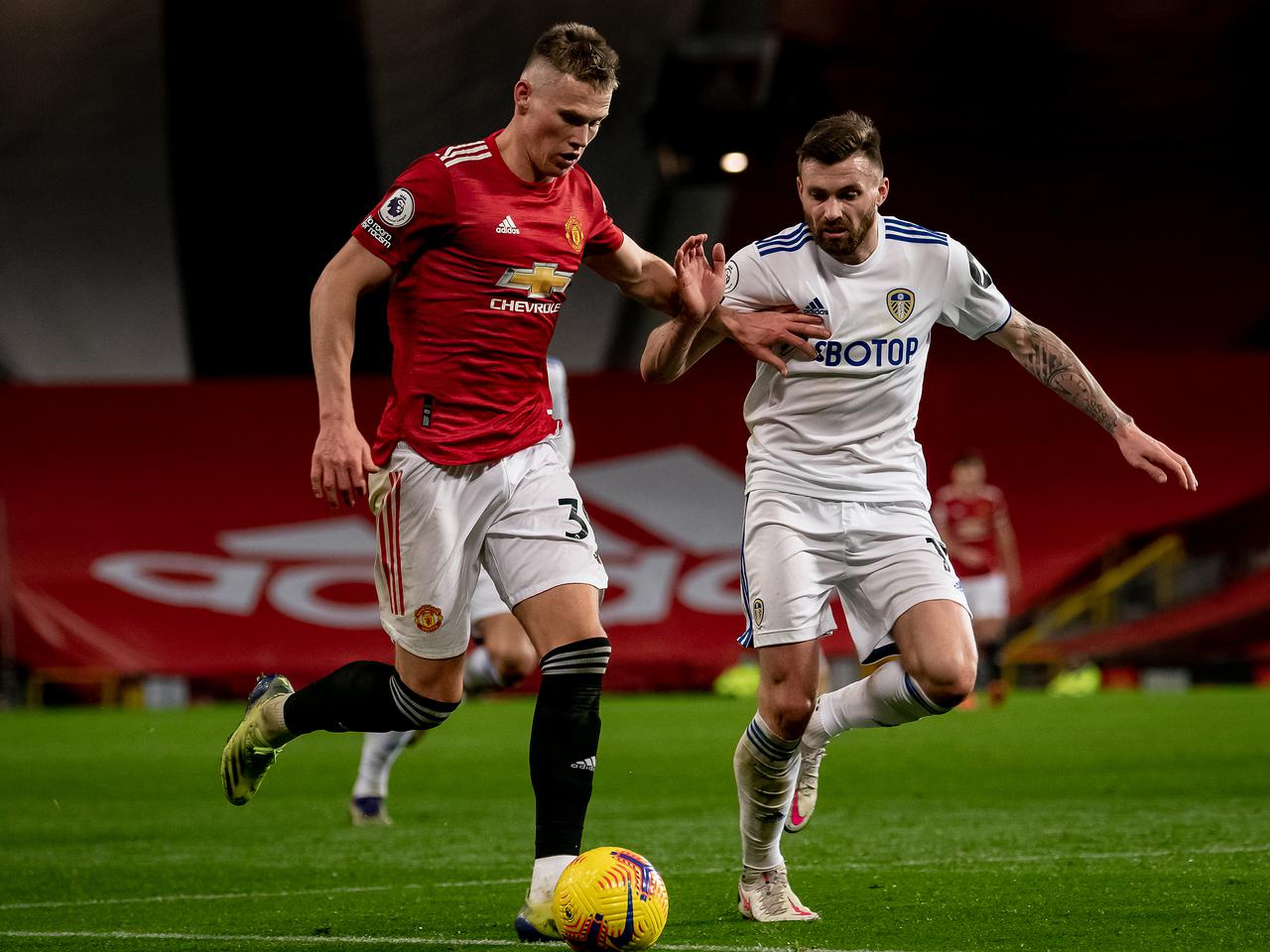 Scott McTominay is challenged by Stuart Dallas