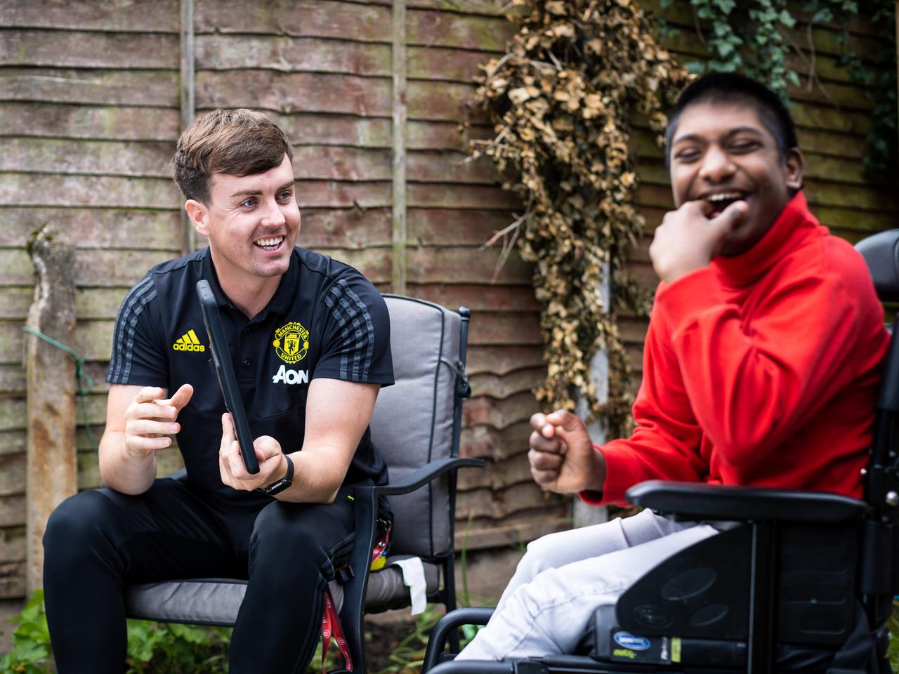 Conor Muldoon from Manchester United Foundation with young student Edwin