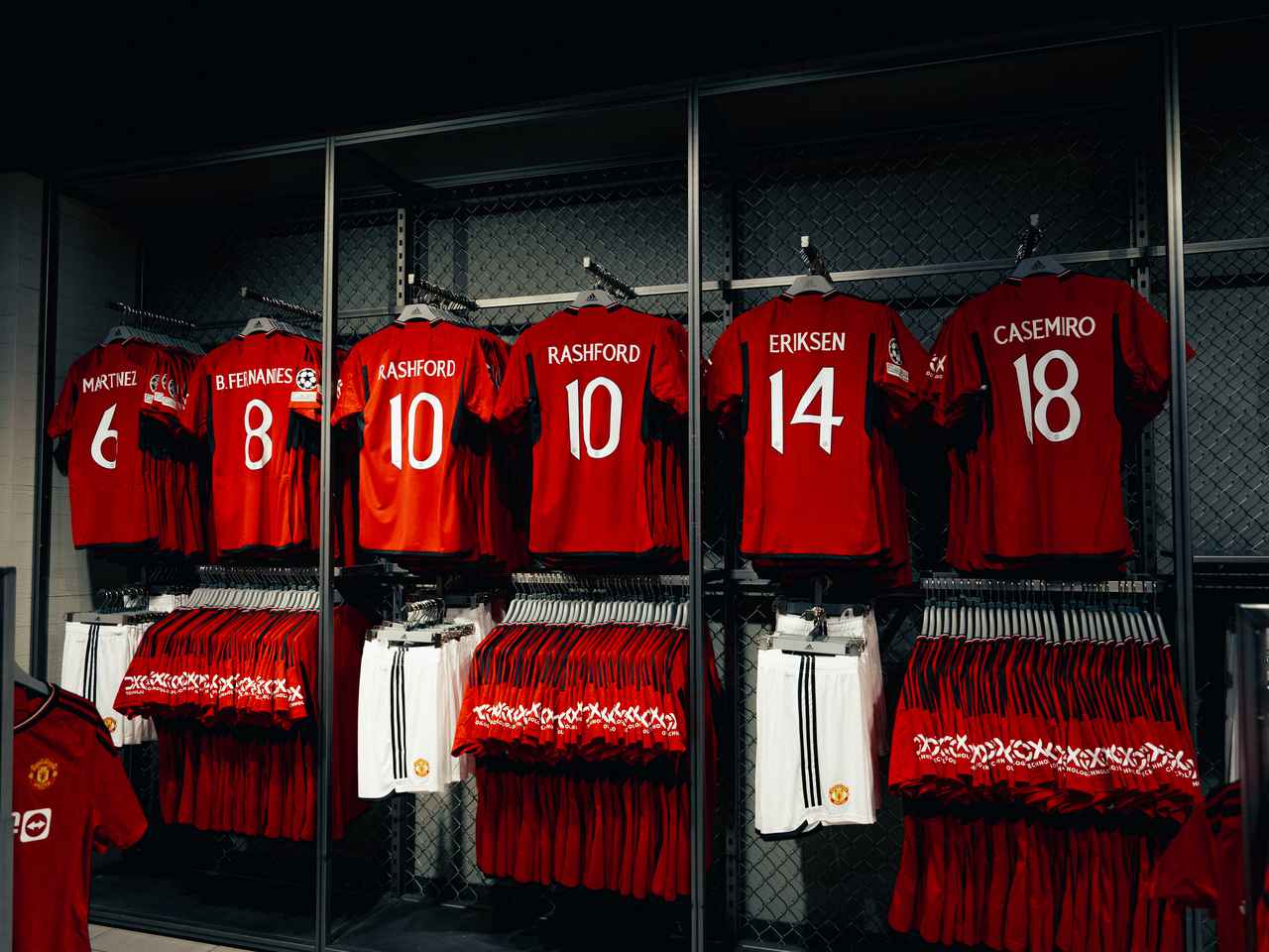 Manchester United shirts with player names and numbers on the back, hanging in the Old Trafford Megastore