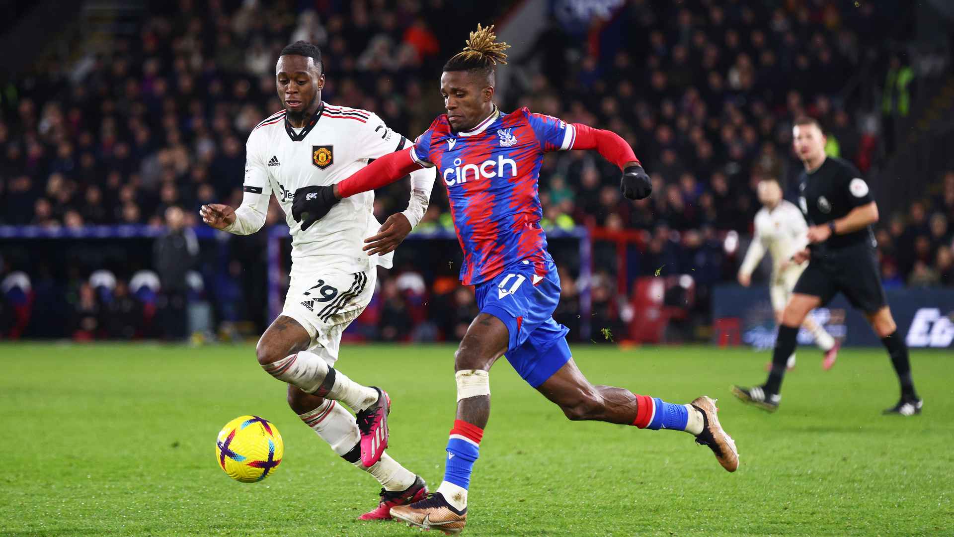 Aaron Wan-Bissaka and Wilfried Zaha in Premier League combat.