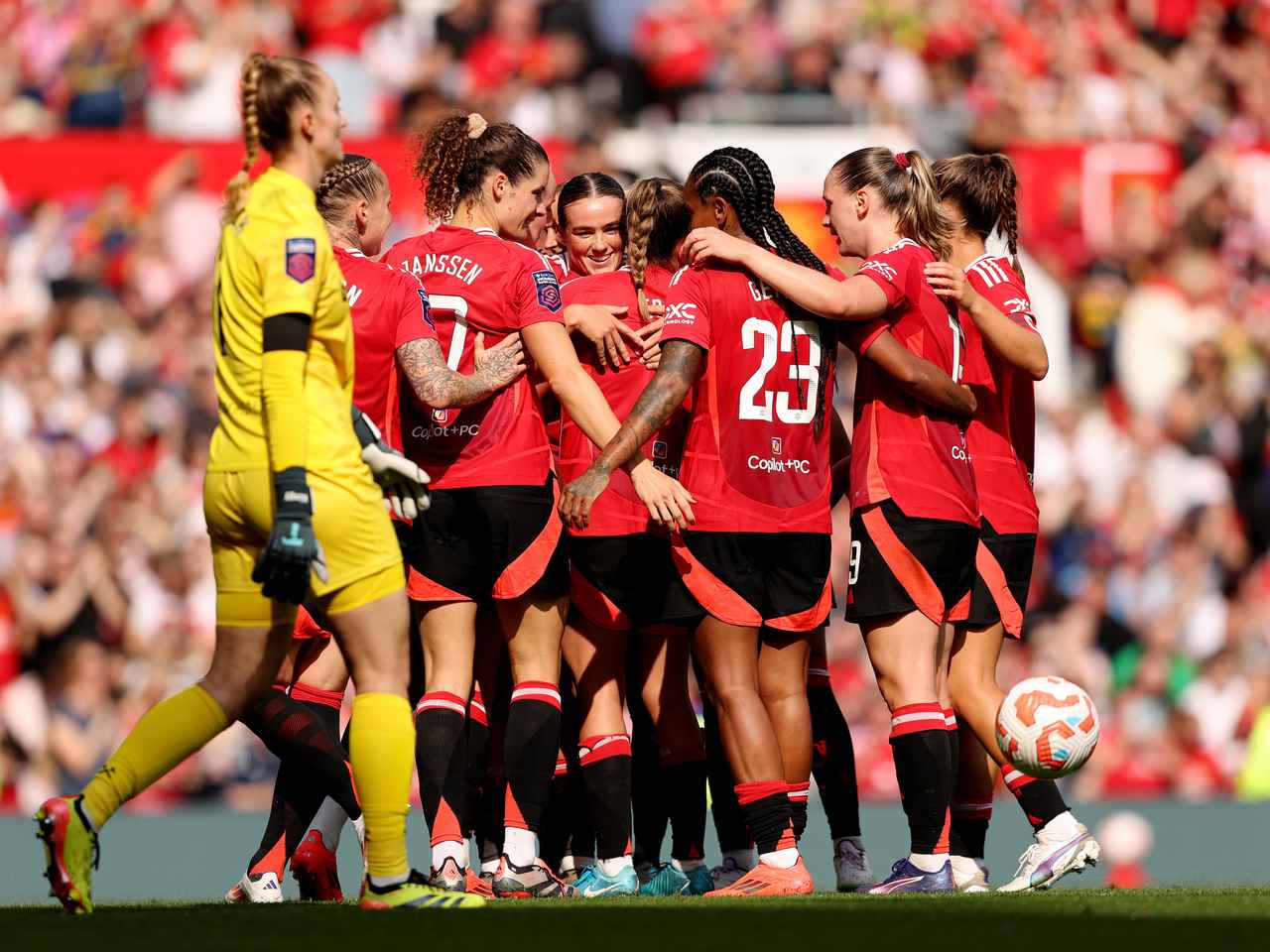 United Women players celebrate against West Ham