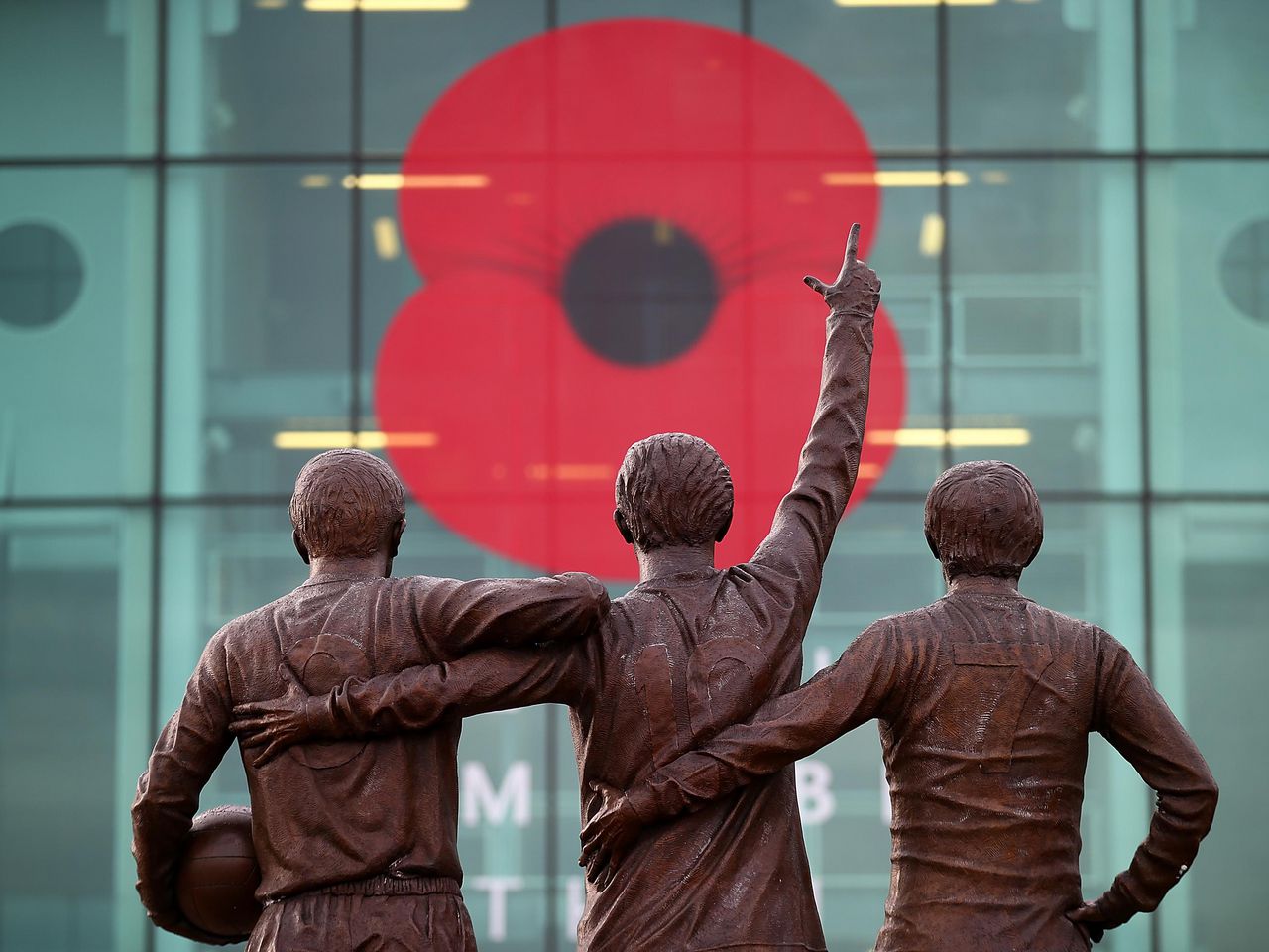 Poppy tribute for Remembrance on the East Stand window at Old Trafford